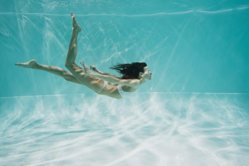 woman swimming under water